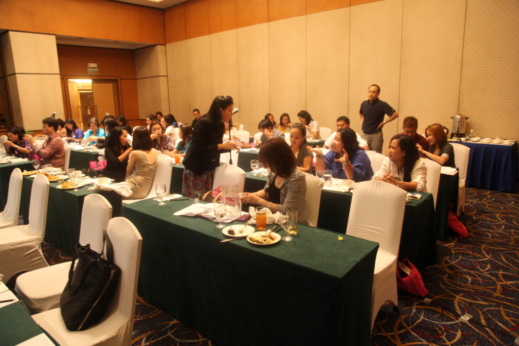 Ms. Sok Koon busily distributing product samples of ACAC formulations for sensory evaluation and answering questions.